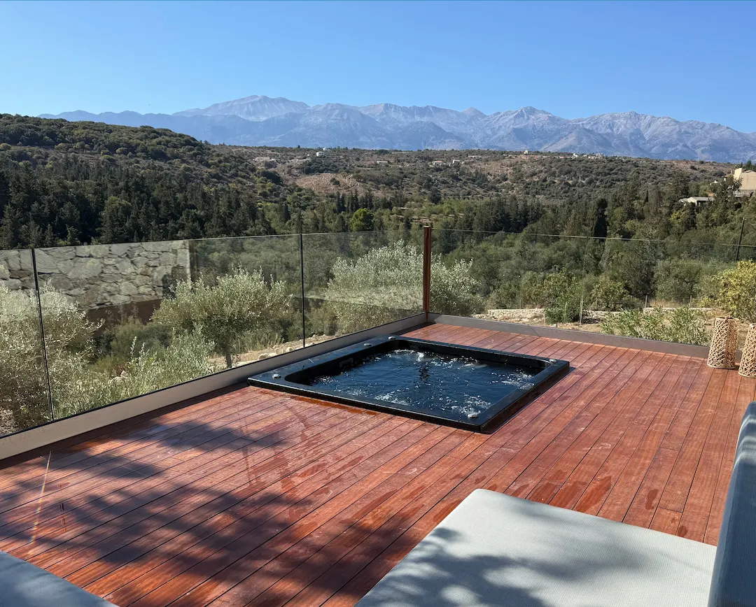 Sunken hot tub with panoramic mountain views